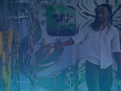 A photo of a Penn State staff member next to an art installation