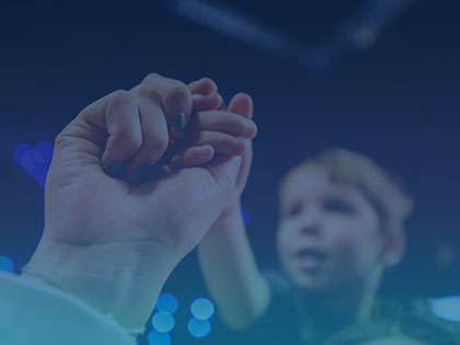 A photo of an adult and a child holding hands