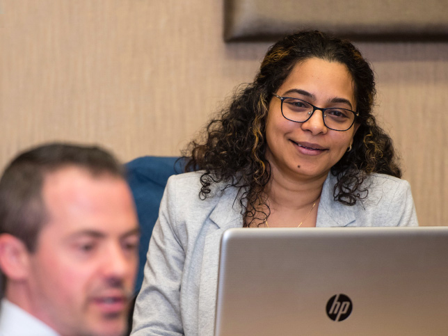 adult learner smiling while looking at laptop