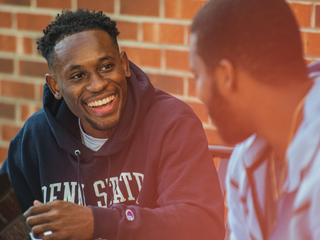 Two students laughing